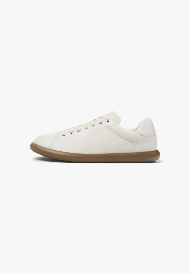 White sneaker with a rounded toe, featuring a lace-up design and a light brown rubber sole. Displayed on a plain white background.