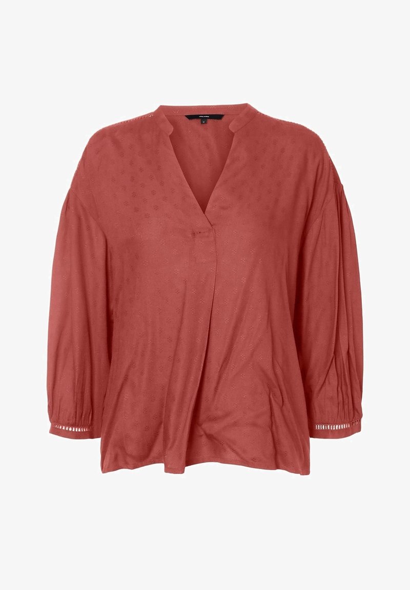 Blusa color óxido con cuello en v, mangas abullonadas de tres cuartos y corte holgado. Presenta sutiles patrones texturizados y detalles decorativos en las mangas.