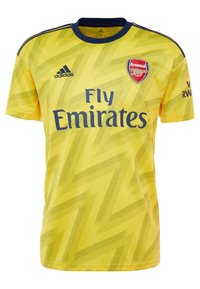 Yellow Arsenal football jersey with blue zigzag pattern, blue collar, Adidas logo, Arsenal crest, and "Fly Emirates" sponsor text.