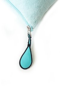 Turquoise cushion with a fuzzy texture, featuring a silver zipper and a teardrop-shaped zipper pull in teal with black edging.