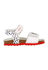 Sandali bianchi con pois neri, cinturino regolabile, suola in sughero, suola rossa, con un logo ben visibile sul cinturino superiore.