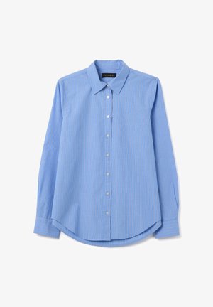 Hellblaues Langarmhemd mit weißen Streifen, spitzem Kragen und geknöpften Manschetten, flach auf weißem Hintergrund ausgebreitet.