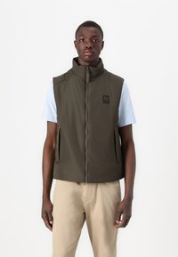 Olive green, sleeveless jacket with high collar, front zipper, and side pockets. Features a small logo on the chest. Pairing with light shirt.