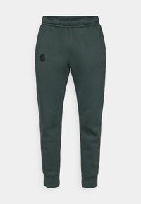 Mørkegrønne tapered joggebukser med elastisk liv og ankelmansjetter, med en liten rund logo på venstre lår.