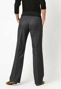 Charcoal gray, tailored trousers with a wide-leg cut, featuring subtle pleats and a comfortable elastic waistband. Smooth, textured fabric.