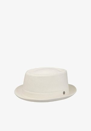 White corduroy fedora hat with a short brim and a small round metal logo tag on the side.