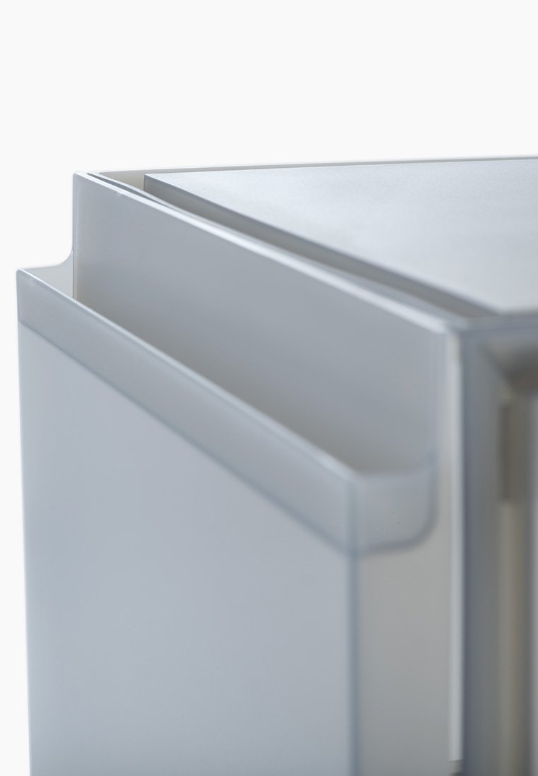 Weißer Kühlschrank in der Ecke mit einer strukturierten Oberfläche, einer flachen Oberseite und einem eleganten grifflosem Design mit leichtem Schwung.