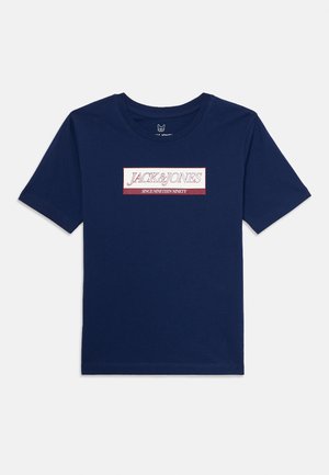 Navy blue short-sleeve t-shirt with "JACK & JONES SINCE NINETEEN NINETY" text in red and white rectangular patch centered on chest.