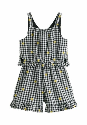 Czarnobiały kombinezon na ramiączkach w kratkę, z żółtą kwiatową haftowaną aplikacją oraz falbankami na krawędziach szortów i w talii.