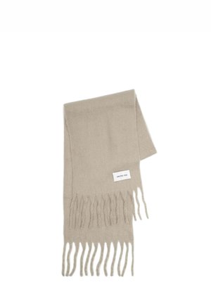 Beige scarf made of soft material, featuring fringe edges and a small label with "ARCTIC FOX" text on one side.