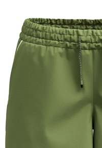 Gröna sweatpants med en strukturerad finish, elastisk midja och justerbar snörning. Har sidofickor och en avslappnad passform.