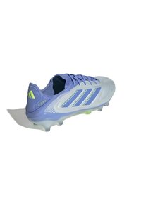 Light purple soccer cleat with grey accents, featuring three contrasting stripes and a textured surface. Clear sole with green spike details.