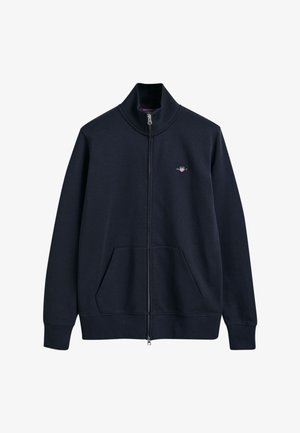Navy Zip-Up Sweatshirt mit hohem Kragen, Fronttaschen, gerippten Bündchen und Saum. Mit kleinem Logo auf der oberen linken Brust.