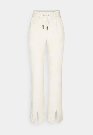 Pantalon taille élastique écru avec cordon, jambes droites et fentes à l'avant de l'ourlet sur chaque jambe.