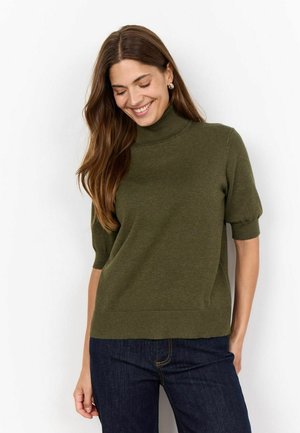Olive green short-sleeve sweater with a high neckline. Smooth texture and ribbed hem. Paired with dark denim jeans.