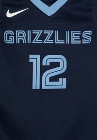 Camiseta de baloncesto azul marino con "GRIZZLIES" en texto azul claro, el número "12" debajo y un logo de Nike blanco en la esquina superior izquierda.