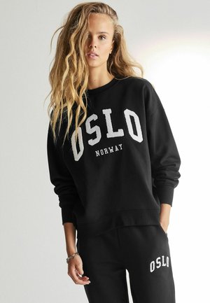 Zwarte sweatshirt met "OSLO" en "NORWAY" in het wit bedrukt. Bevat een ronde hals en geribbelde manchetten. Draag het met bijpassende zwarte broek.