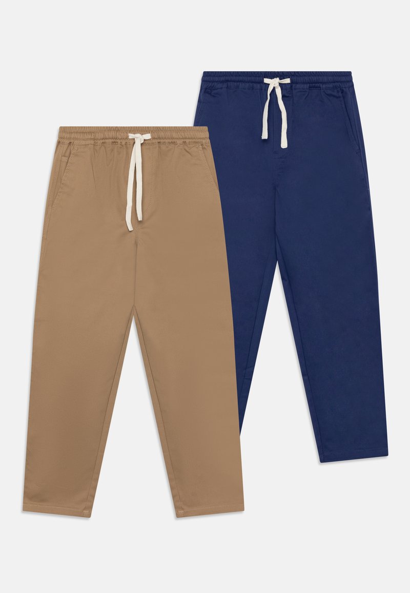 Pantalon beige et marine. Tissu doux, taille élastique avec cordon blanc, poches latérales, design fuselé.