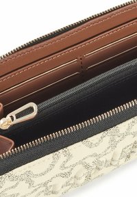 Wallet featuring a textured cream exterior with a black zipper, brown interior, card slots, and a gold zipper for secure closure.