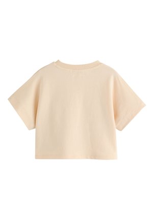 T-shirt à manches courtes et col rond en coton pêche doux. Design simple, coupe décontractée, avec des coutures visibles au niveau de l'encolure et des bords des manches.