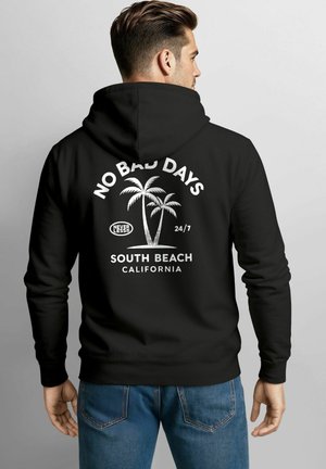 Black hoodie featuring white graphic text "NO BAD DAYS" and palm tree design, with "SOUTH BEACH CALIFORNIA" below, made of cotton material.