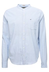 Light blue long-sleeve shirt made of stretch fabric, featuring a buttoned front, mandarin collar, and a small chest pocket with logo.