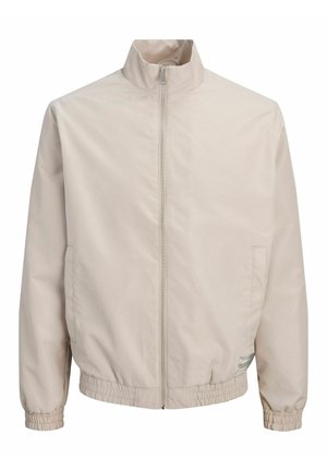 Beige Zip-Up-Jacke mit hohem Kragen, elastischen Bündchen und Saum sowie dezenten Seitentaschen.