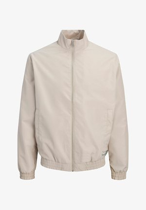 Beige Zip-Up-Jacke mit hohem Kragen, elastischen Bündchen und Saum sowie dezenten Seitentaschen.