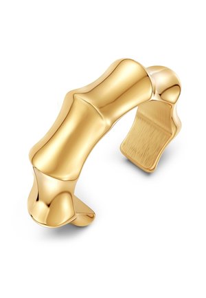 Zlato obarvana bangleska zapestnica z zasnovo, ki je navdihnjena z bambusom, s gladkimi, ukrivljenimi površinami in teksturiranim notranjim zaključkom.