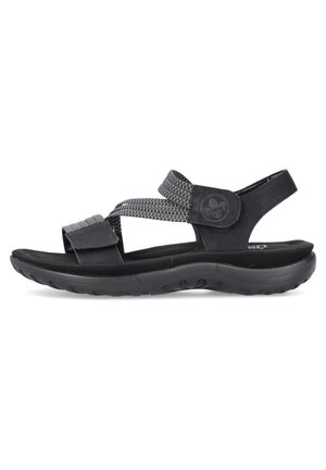 Sandales noires avec des bandes réglables, dotées d'un tissu texturé et d'une cuir lisse. La semelle est en caoutchouc avec un motif pour une meilleure adhérence.