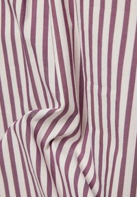Cotton fabric with vertical stripes in purple and white. The texture appears soft with a slight sheen, featuring flowing, draped folds.