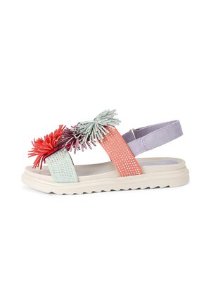 Flat sandal with white sole, purple ankle strap, coral and mint green front straps, decorated with red, purple, and mint green tassels.