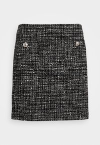 Svart och vit tweed kort kjol med en texturerad tyg, två silverknappar framtill och en rak skärning.
