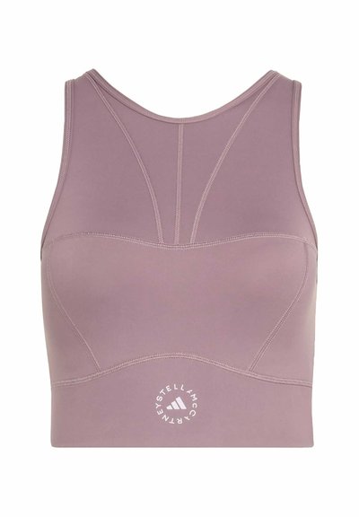 Mauve sports bra with racerback design, contoured stitching, and round Stella McCartney Adidas logo at the bottom center front.