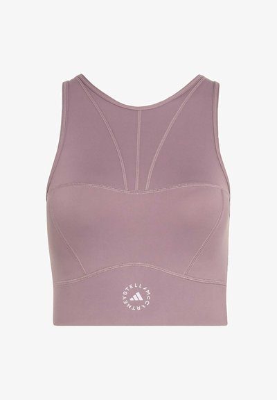 Mauve sports bra with racerback design, contoured stitching, and round Stella McCartney Adidas logo at the bottom center front.