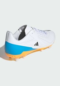 White athletic shoe with a blue and orange gradient sole. Features a textured upper, laces, and triangular logo accents. Transparent studs on the sole.