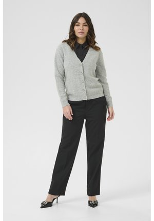 Gray cardigan made of soft material with a v-neck, button closure, and long sleeves. Paired with black trousers and pointed-toe heels.