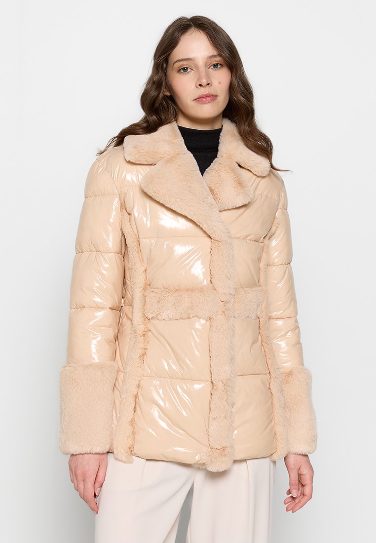 Beige Puffer-Jacke mit glänzender Oberfläche und strukturiertem Kunstfellkragen sowie -manschetten. Sie verfügt über ein gestepptes Muster und ein gerades Design.