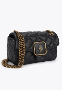  Czarna skórzana torba na ramię z pikowanym wzorem, złotym łańcuszkowym paskiem oraz ozdobną klamrą z motywem ręki otoczonej ćwiekami.