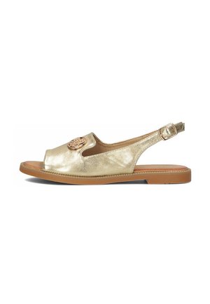 Złote skórzane sandały na obcasie z otwartym noskiem, ze okrągłym akcentem na cholewce, teksturowanym wykończeniem i brązową gumową podeszwą.