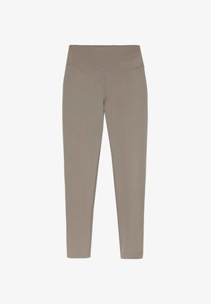 Eng anliegende Leggings in einem matten Beige, hergestellt aus glattem, dehnbarem Material. Sie verfügen über einen hohen Taillenbund und sind nahtlos.