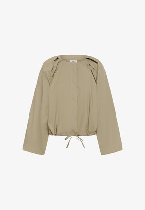 Bézs színű hosszú ujjú dzseki, húzott szegéllyel és kötőfűzővel, kerek nyakkivágással, sima, laza szabással.