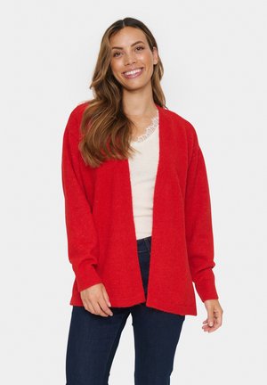 Cardigan rosso realizzato in morbido materiale a maglia, con apertura frontale, vestibilità comoda, maniche lunghe e orlo dritto.