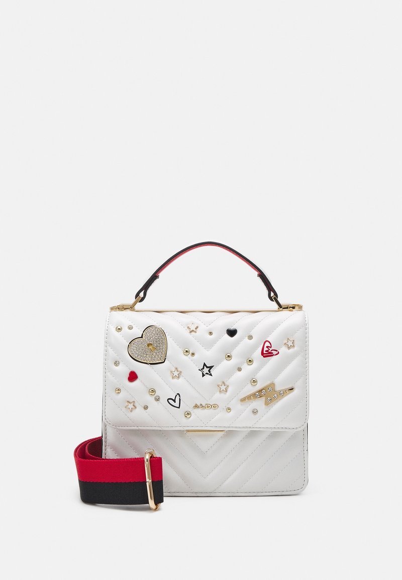 Sac à main matelassé blanc avec des clous dorés, ornements en forme de cœur et d’étoile, bandoulière détachable noire et rouge, et poignée supérieure.
