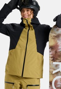 Snowboard jacket in yellow and black, featuring zippered pockets, hood, and sleek design. Includes snowboard with a textured, forest-patterned surface.
