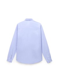 Camisa de manga larga azul celeste con cuello abotonado, yugo trasero y dobladillo redondeado. La tela presenta una sutil textura. Detalle de puños abotonados.