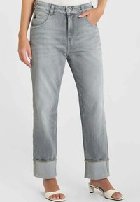 Lichtgrijze denim jeans met een rechte pijpvorm, voorzien van opgerolde boorden, vijf zakken en een knoopsluiting. Gladde textuur en minimale slijtage.