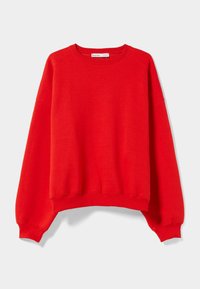 Sweatshirt rouge en tissu doux, doté d'un col rond, d'épaules tombantes, et de poignets et ourlet côtelés. Design simple et épuré.
