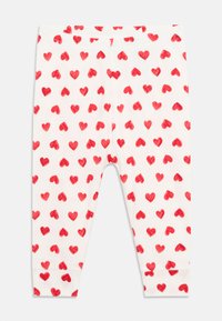Leggings i hvit stoff med et gjentatt mønster av røde hjerter. Designet inkluderer mansjetter ved anklene og et elastisk liv.
