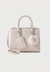 Beige synthetic handbag with dual handles, detachable shoulder strap, fur pom-pom accent, and cardholder attachment. Smooth texture.